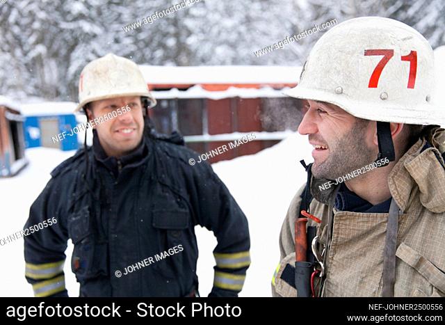 Smiling firefighters talking