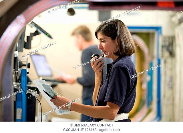Astronaut Nicole Stott, Expedition 2021 flight engineer, uses a communication system during a training session in an International Space Station mock-uptrainer...