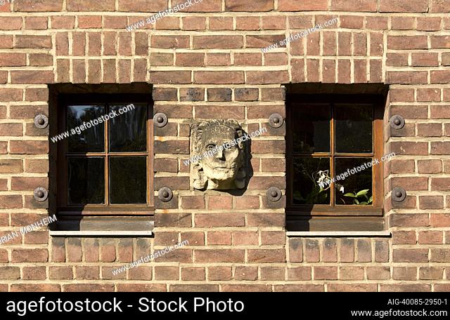 Detail of gargoyle and windows on facade of brick house, built by Karl Buschhuter, 1910, Germany