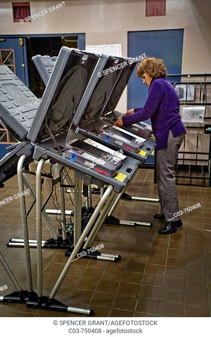 On the eve of Election Day, a volunteer poll worker prepares a polling place in San Juan Capistrano, CA, USA (note electronic voting machines)
