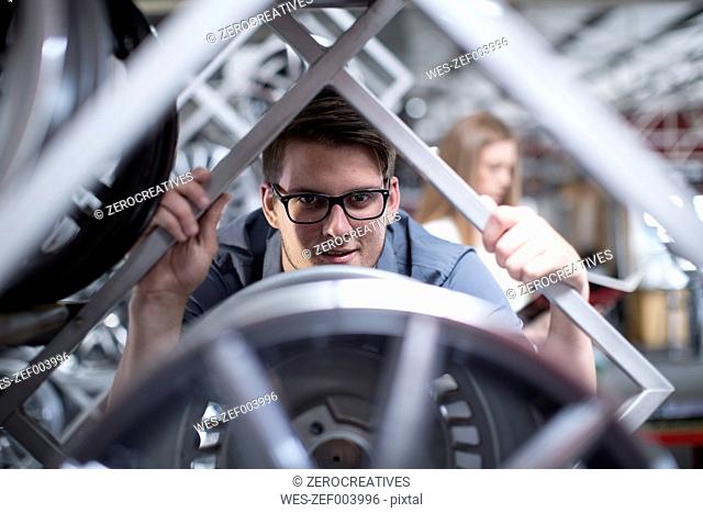 Customer inspecting a tyre in a tyre shop