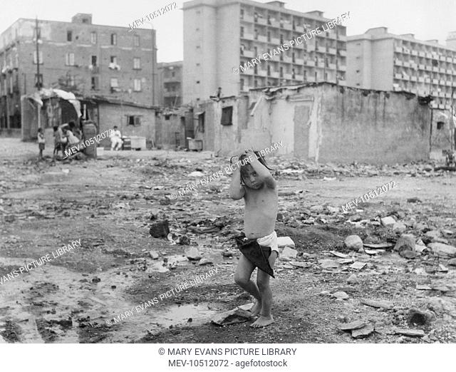 Street Children - Naples, Italy. The 'Scunizzi' street urchins, running wild amid the bombed buildings of Naples. The priest Father Mario Borrelli achieved...