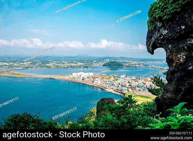 Panoramic view of seaside village from Seongsan Ilchulbong Tuff Cone in Jeju Island, Korea