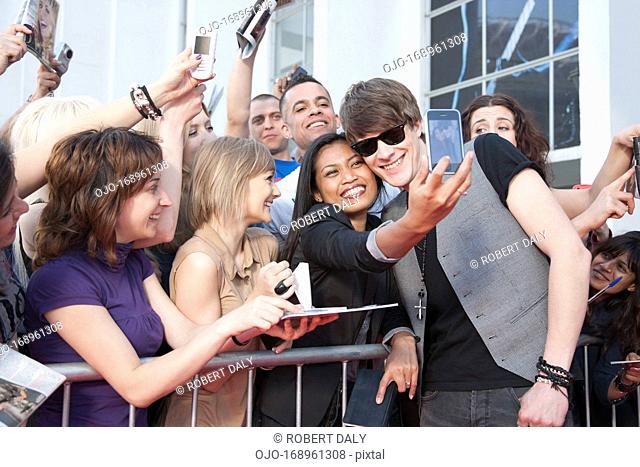 Celebrity taking pictures with fans
