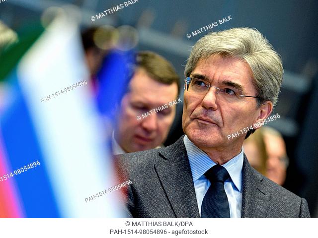 Joe Kaeser, Chairman of the Board of Siemens, sitting behind a Russian flag during the signing of an agreement between the German company Siemens Russia and...