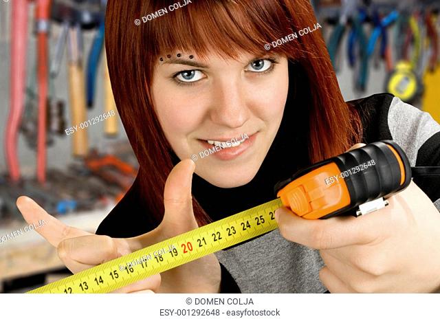 Redhead girl with measuring tool ruler