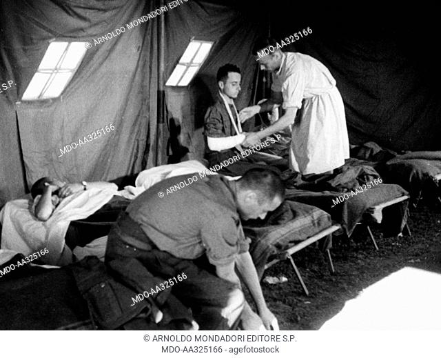 Wounded Italians are visited. A doctor visiting the wounded Italians admitted in a field hospital No 239 tent. Russia, August 1942