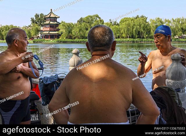 Swimmers chat at usually busy touristic area of Houhai lake in Beijing, China on 07/07/2020 The Chinese capital took strict measures to stop the spread of...