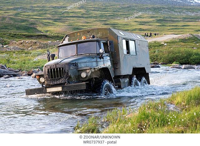 Russian truck Ural crossing a small river