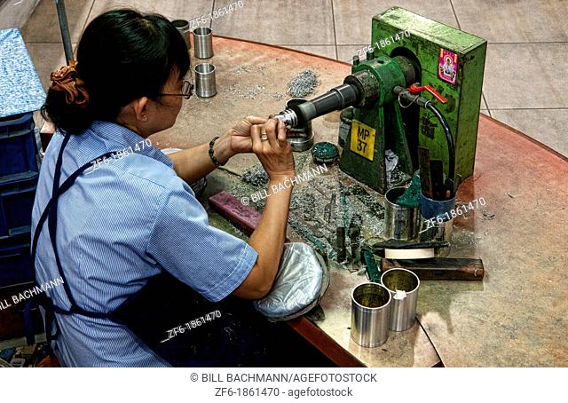Worker finishing product design in Pewter Factory called Royal Selangor in Kuala Lumpur Malaysia Asia