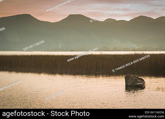 Long exposure photograph of solitary stone in lake