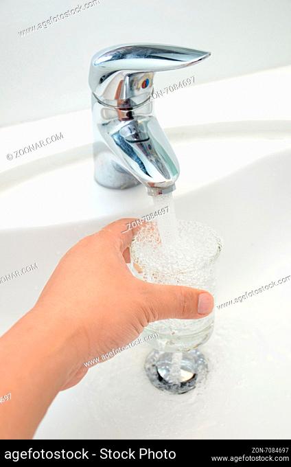 Filling glass of water from stainless steel faucet