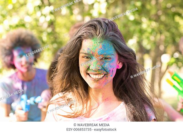 Happy girl covered in powder paint