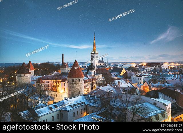 Tallinn, Estonia. Night Starry Sky Above Old Castle Walls Architecture. Cityscape Skyline In Old Town. Winter Evening Night. Famous Landmark