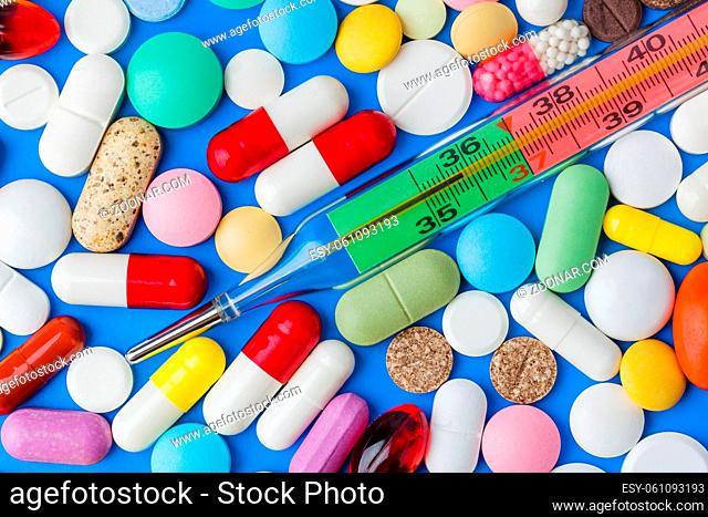 Pills and thermometer - abstract medical background