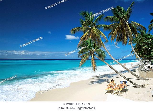 Sunbathers on Worthing Beach, on the south coast, Christ Church, Barbados, West Indies, Caribbean, Central America