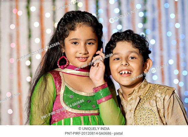 Children talking on a mobile phone on Diwali