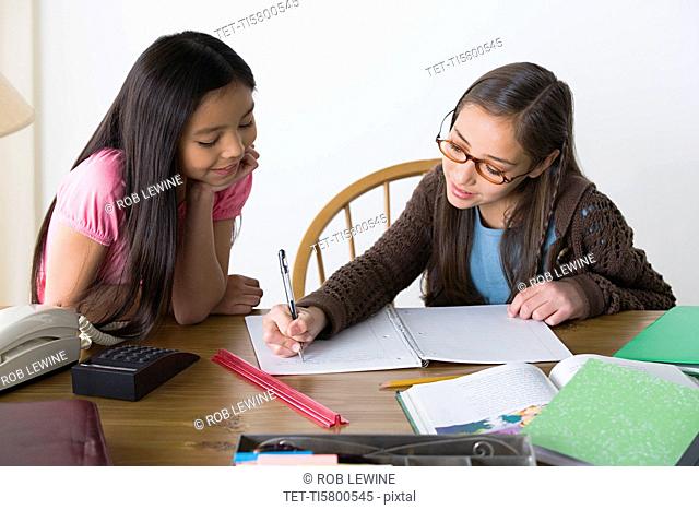 Sisters 8-9, 10-11 doing homework