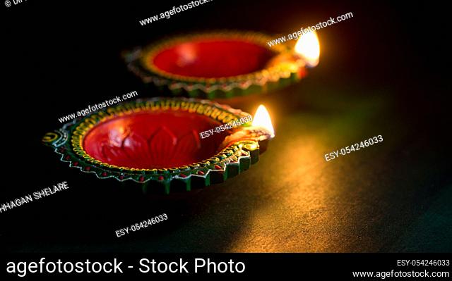 Happy Diwali - Clay Diya lamps lit during Diwali celebration. Greetings Card Design of Indian Hindu Light Festival called Diwali
