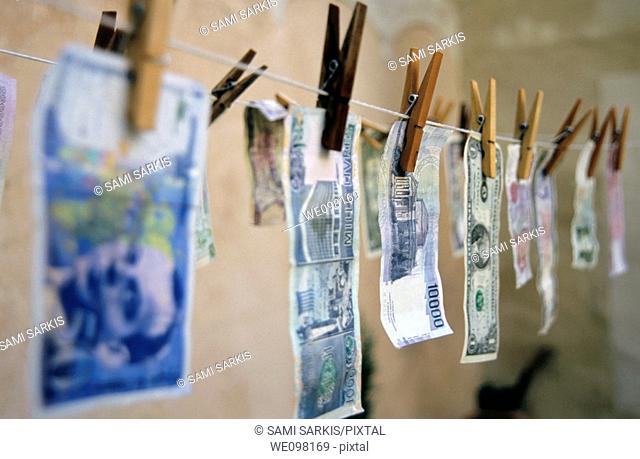 International banknotes drying on a washing line