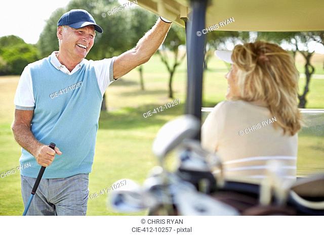 Senior couple in golf cart