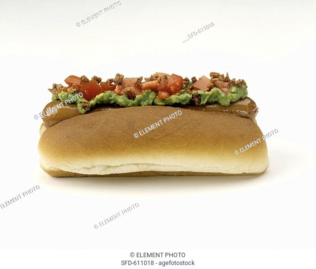 Hot Dog on Roll with Guacamole, Bacon and Tomatoes