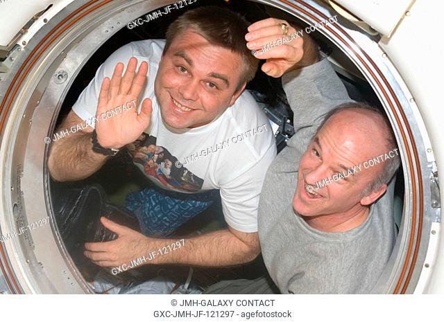 NASA astronaut Jeffrey Williams (right), Expedition 22 commander; and Russian cosmonaut Maxim Suraev, flight engineer, wave good-bye to their crewmates on the...