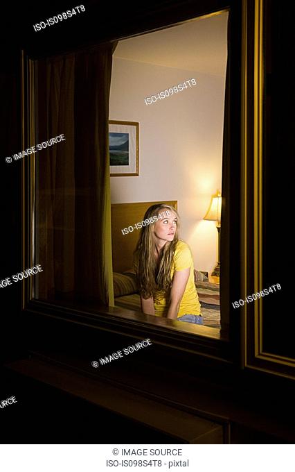 Young woman in motel room