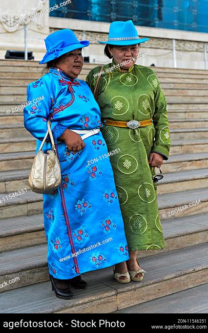 Zwei ältere Damen in Festtagskleidung und blauen Hüten in Pose am Festival der mongolischen Nationaltracht, Ulanbator, Mongolei / Two elderly ladies in festive...