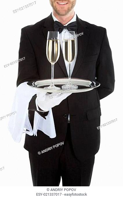 Waiter Carrying Champagne Flutes On Tray