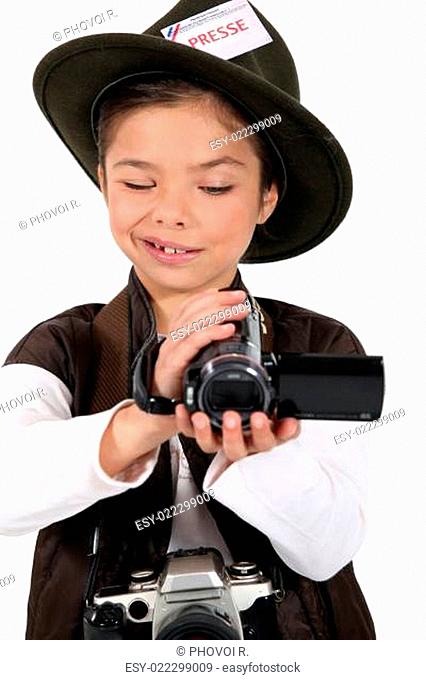 portrait of a little girl dressed as a photographer