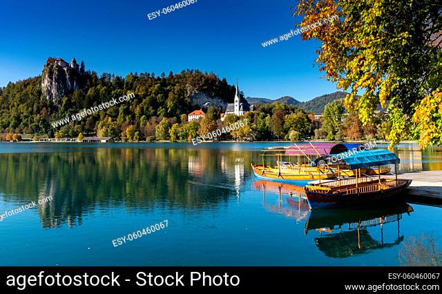 Bled, Slovenia - 18 October, 2021: A view of Lake Bled with the Bled Castle and village in autumn and snow-covered Julian Alps in the background
