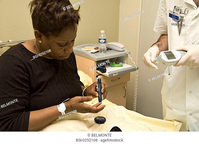 Photo essay from hospital. Department of diabetology endocrinology at Saint Louis Hospital in Paris. Glycemia test. The patient stings her finger with a lancing...