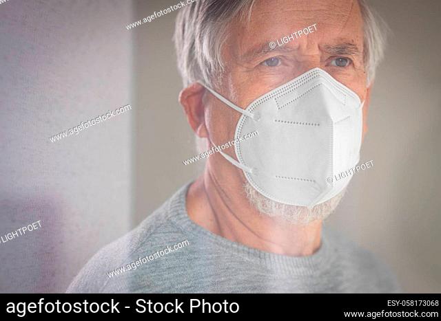 Senior man wearing a facemask during coronavirus and flu outbreak. Virus and illness protection, home quarantine. COVID-19 concept