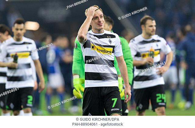 Moenchengladbach's Patrick Hermann (C) walks off the pitch after the UEFA Europa League round of 16 first-leg soccer match between FC Schalke 04 and Borussia...