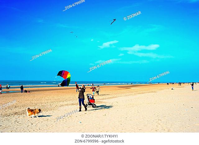 ZEEDIJK, AMSTERDAM, NETHERLANDS - MARCH 08, 2014: Unidentified people having fun at the ocean beach in the sunshine day