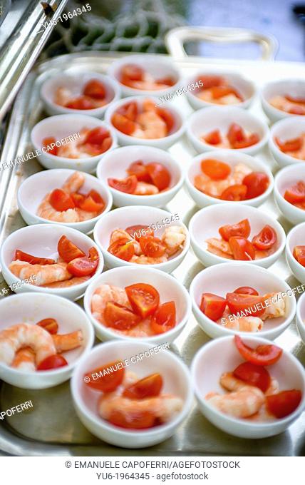 Bowls with shrimp and tomatoes