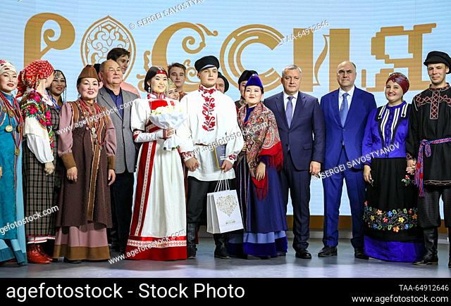 RUSSIA, MOSCOW - NOVEMBER 17, 2023: Irkutsk Region Governor Igor Kobzev (4th R) is seen with bride Yelena Tumurova and groom Mark Prasolov (L-R front) during a...