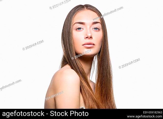 Beautiful young woman with straight healthy hair and natural make-up. Isolated on white background. Copy space