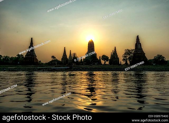 The view of Wat Chaiwatthanaram taken during sunset hours with the reflection on the chao phraya river. Ayutthaya, Thailand