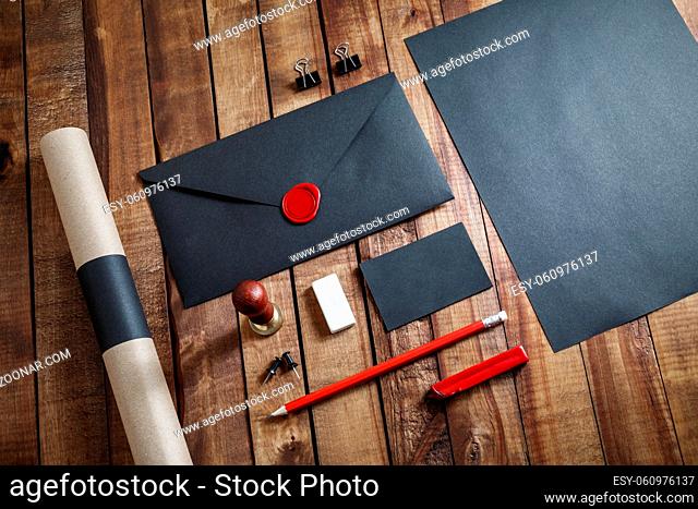 Blank black stationery set on vintage wood table background. Mock up for branding identity. ID template. Flat lay