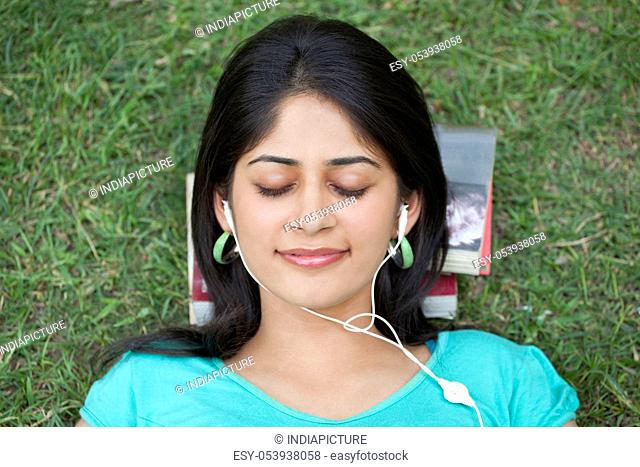 Close-up of woman listening to music