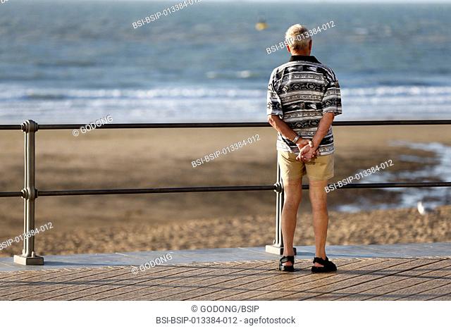 Retired man watching the sea
