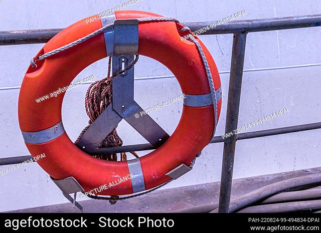 23 August 2022, Mecklenburg-Western Pomerania, Wismar: A life preserver hangs from a railing on the building dock in the otherwise empty shipbuilding hall of...
