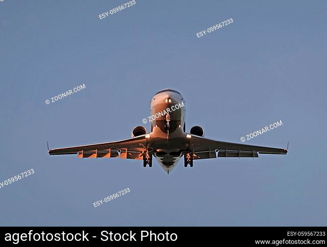 Airplane flies against a background of blue sky