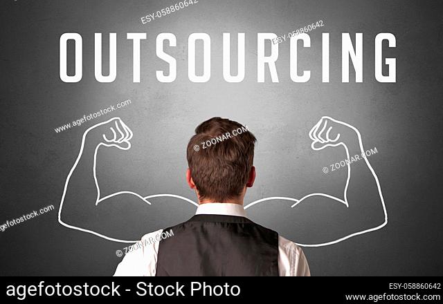 Rear view of a businessman with OUTSOURCING inscription, powerfull business concept