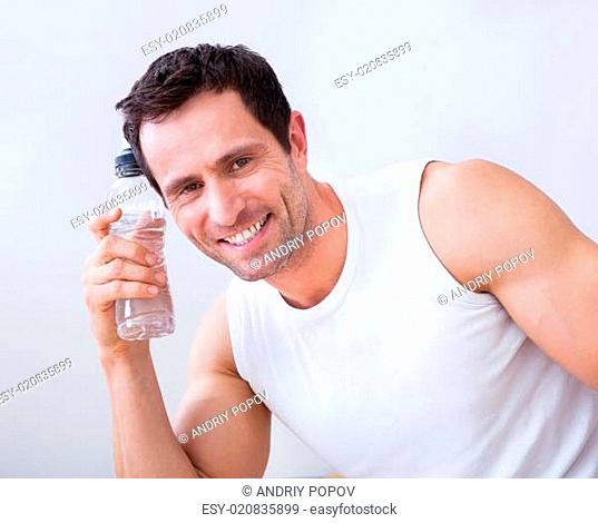 Young Man Holding A Bottle Of Water
