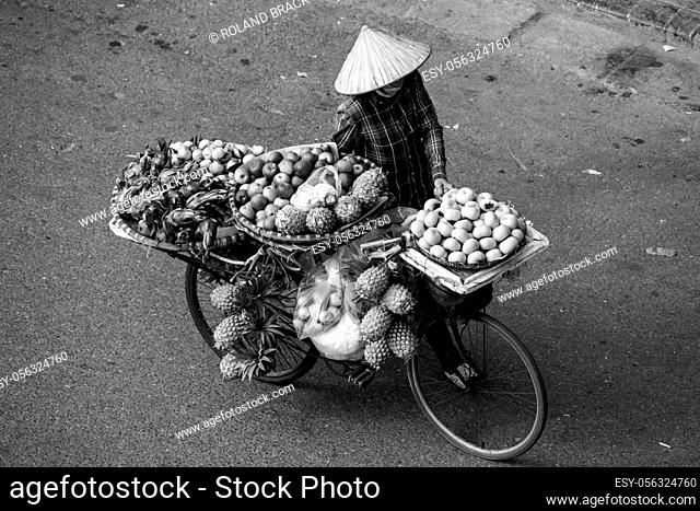 Transport of fruits on a bicycle in the streets of Hanoi in Vietnam