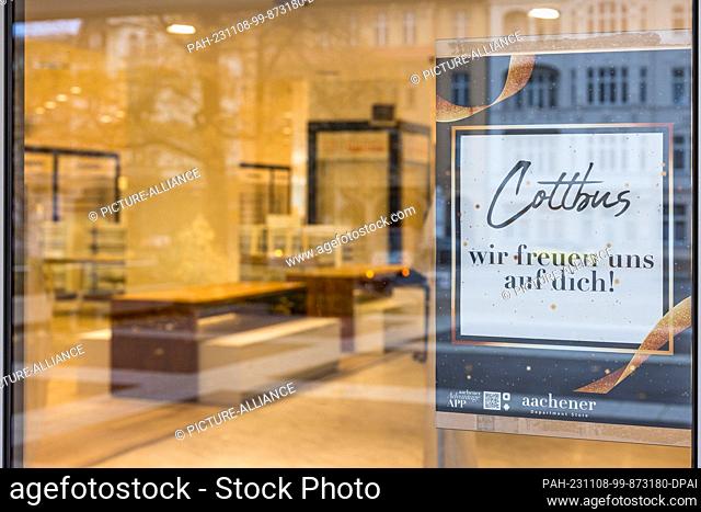 08 November 2023, Brandenburg, Cottbus: An image poster hangs in a shop window of the fashion store ""Aachener"", which has not yet opened