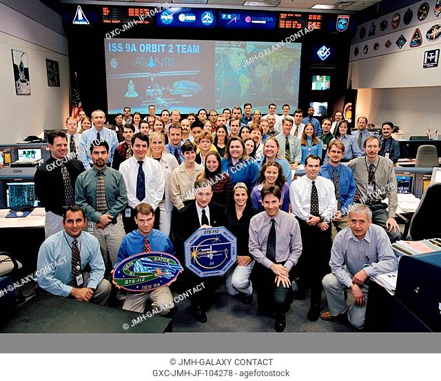 The members of the STS-112ISS-9A Orbit 2 Team pose for a group portrait in the station flight control room (BFCR) in Houston's Mission Control Center (MCC)